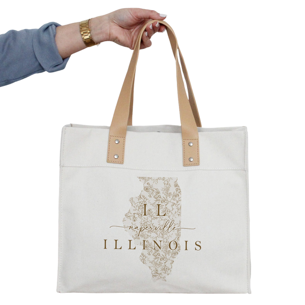 a person holding a white tote bag