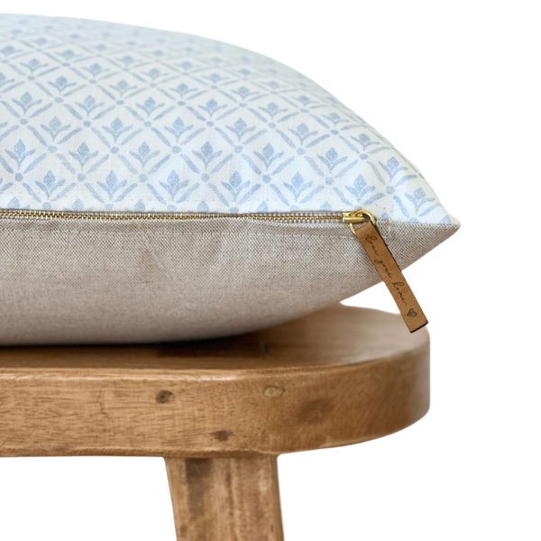 a pillow sitting on top of a wooden chair