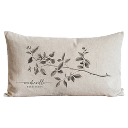 a white pillow with a branch on it