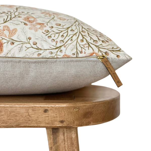 a pillow sitting on top of a wooden stool