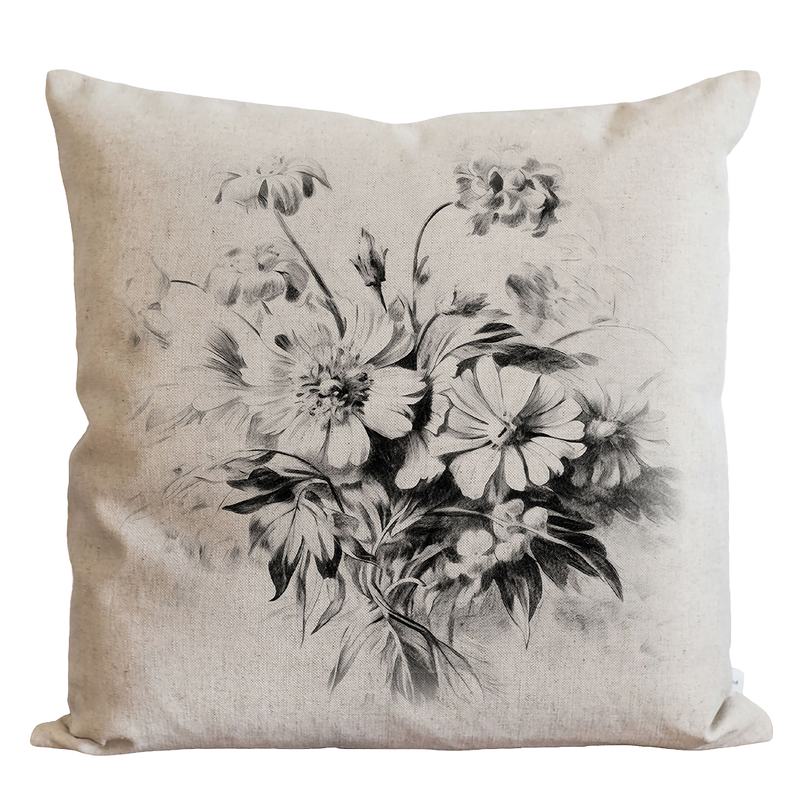 a black and white picture of flowers on a pillow