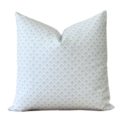 a white and blue pillow on a black background