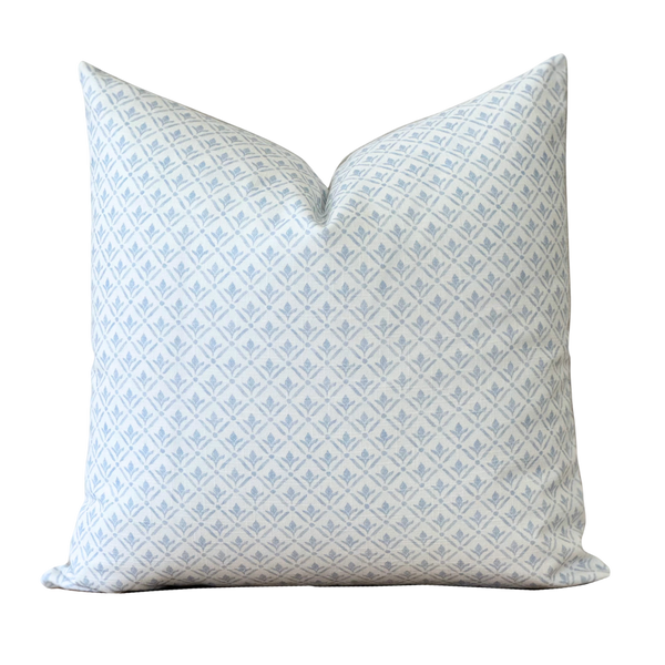 a white and blue pillow on a black background