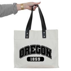 a person holding a white bag with oregon on it