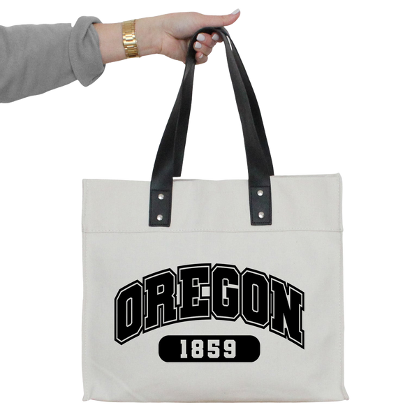 a person holding a white bag with oregon on it