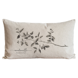a black and white pillow with a branch on it