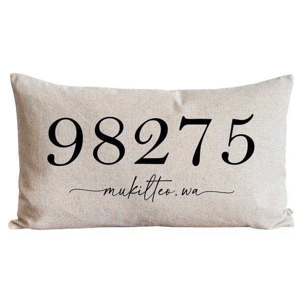 a white pillow with a black lettering on it