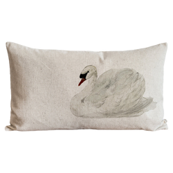 a white pillow with a picture of a swan on it