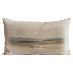 a pillow with a painting of a landscape on it