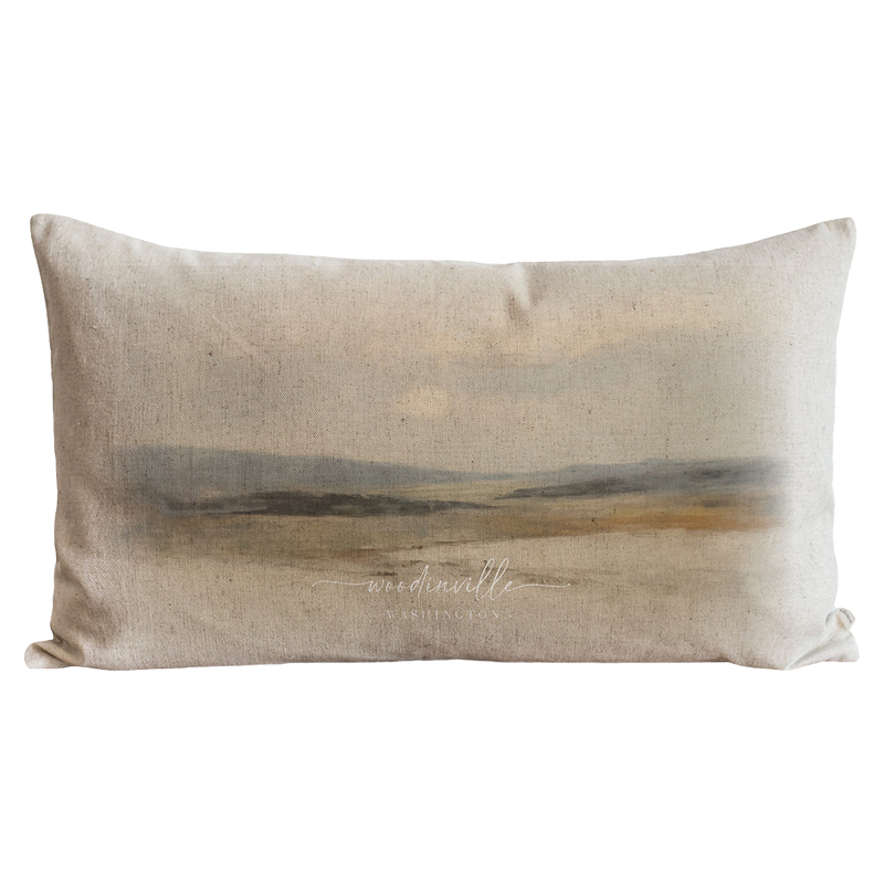 a pillow with a painting of a landscape on it