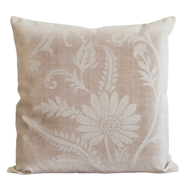 a white pillow with a flower design on it
