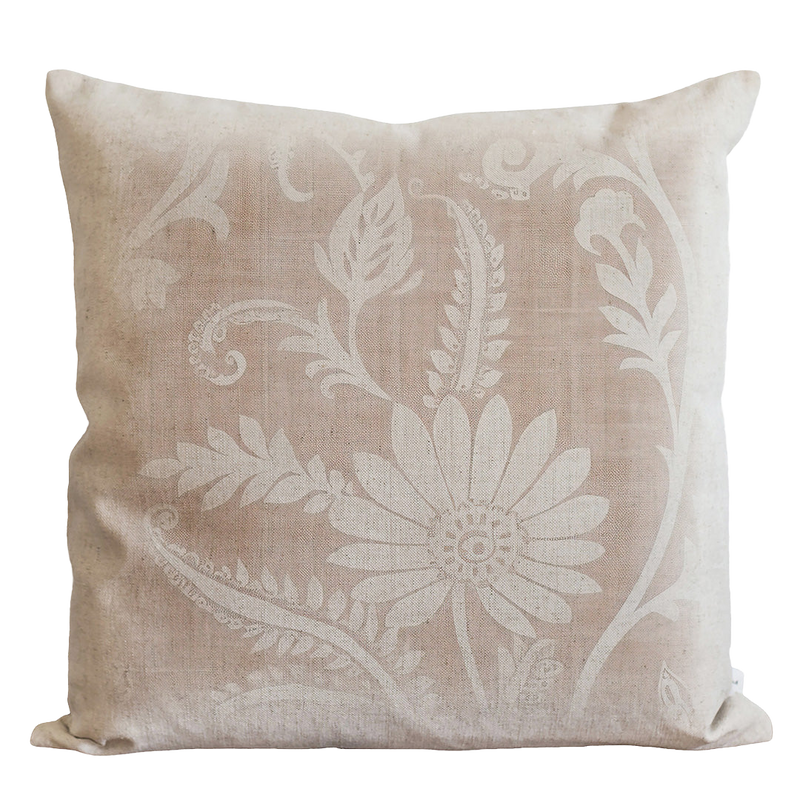 a white pillow with a flower design on it