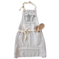 a white apron with two wooden spoons in it