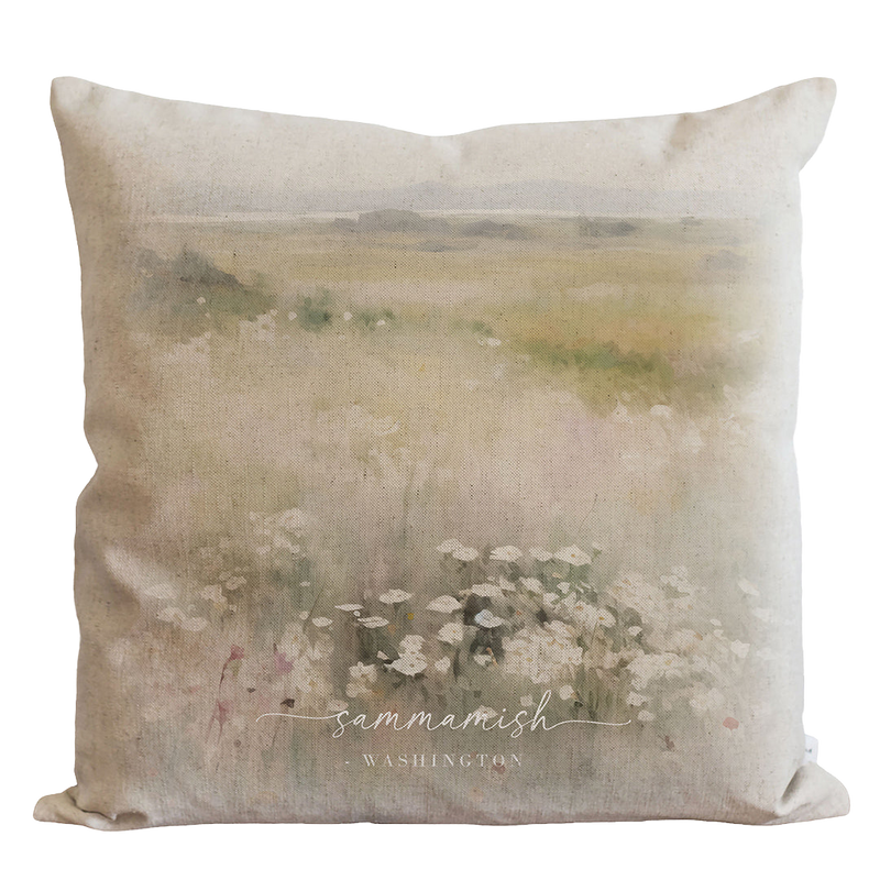 a pillow with a painting of flowers on it