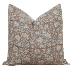 a brown and white pillow on a black background